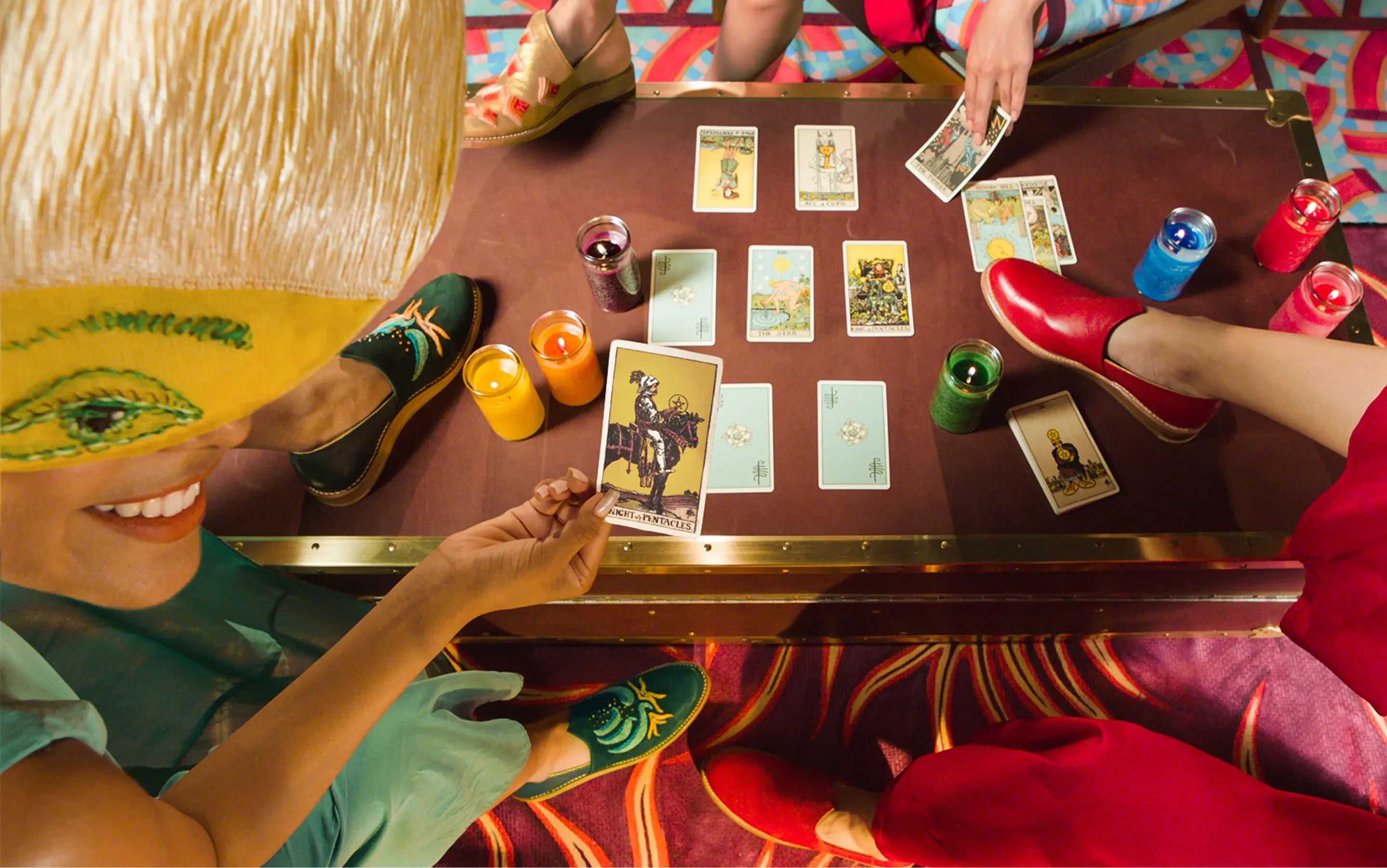 Bathke Bespoke: group tarot-card reading with several people wearing the loafers around a table