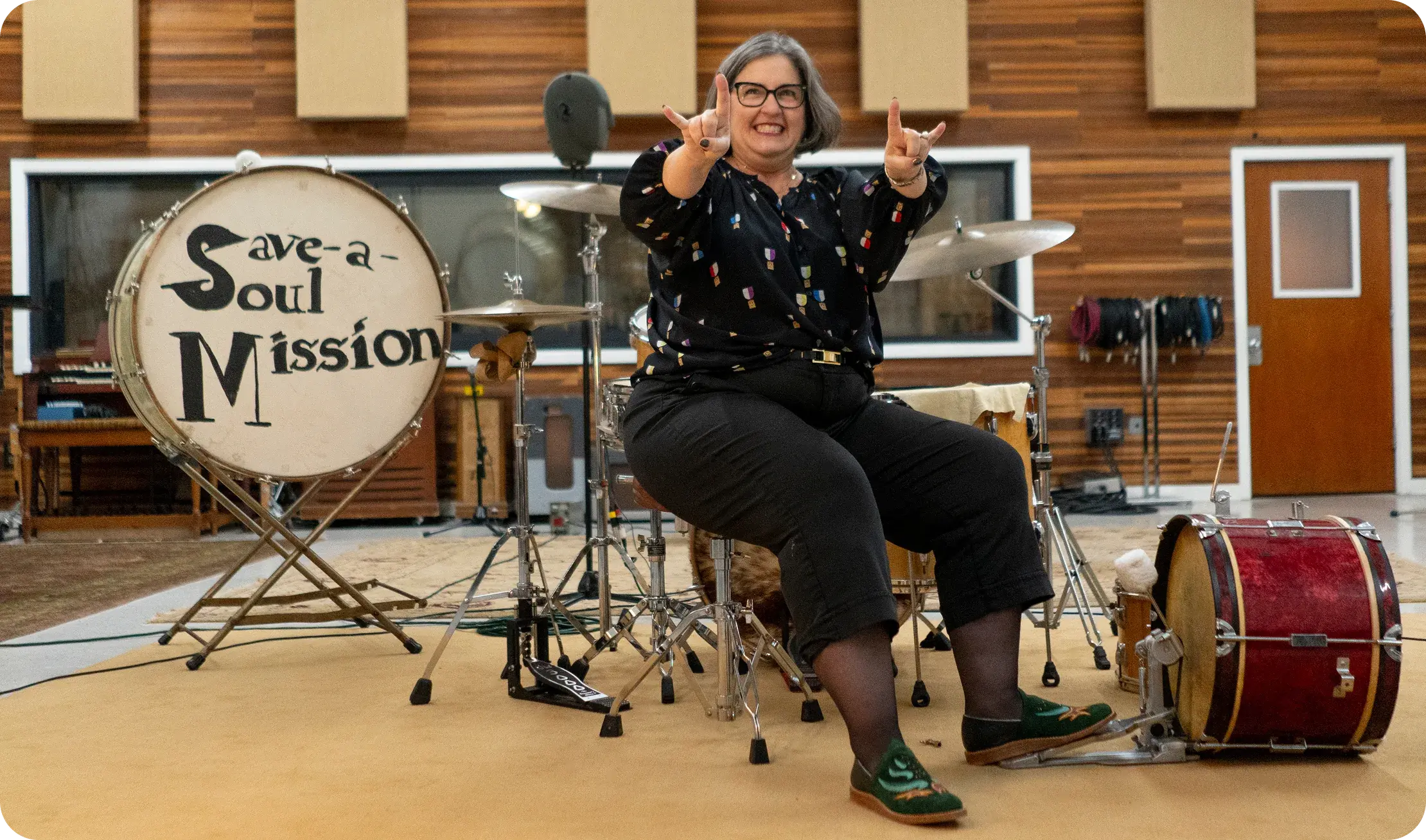 Bathke Bespoke: a woman wearing the shoes drumming in a recording studio