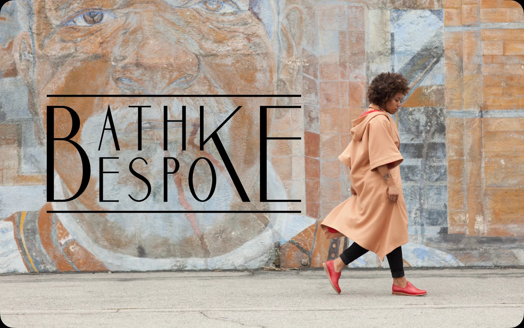 Bathke Bespoke campaign cover: the logotype over a painted mural, model in a camel coat